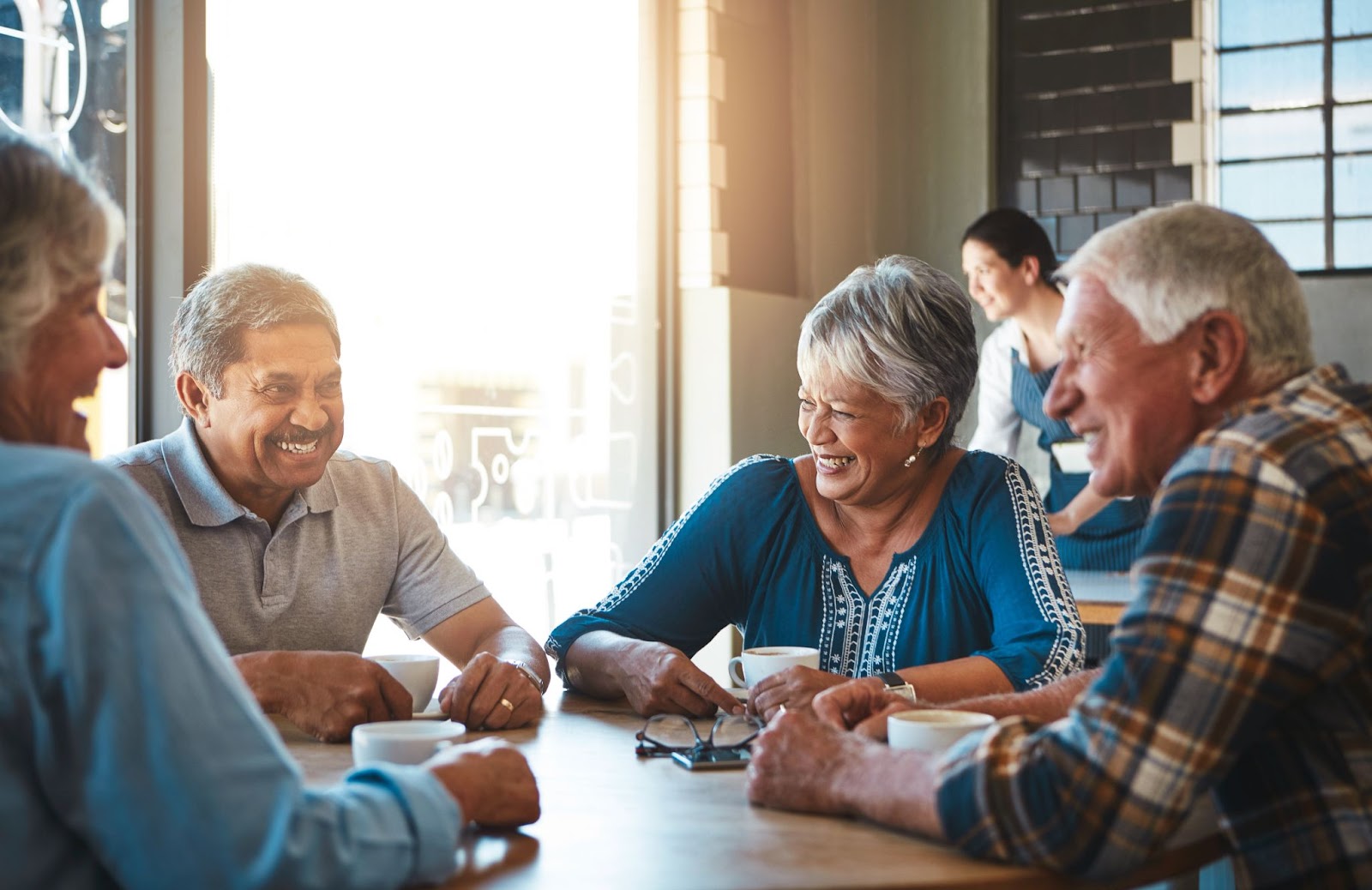 A group of seniors grabbing coffee at their retirement community together.